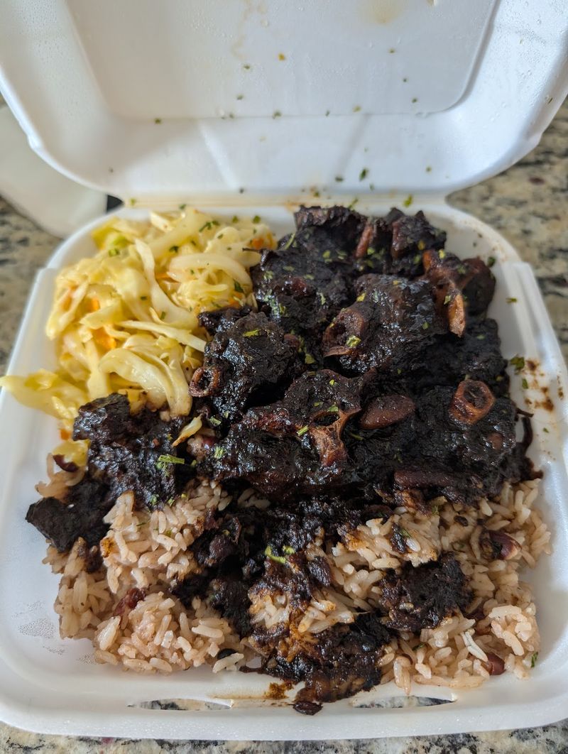 Jerk oxtail over rice and peas with mac and cheese