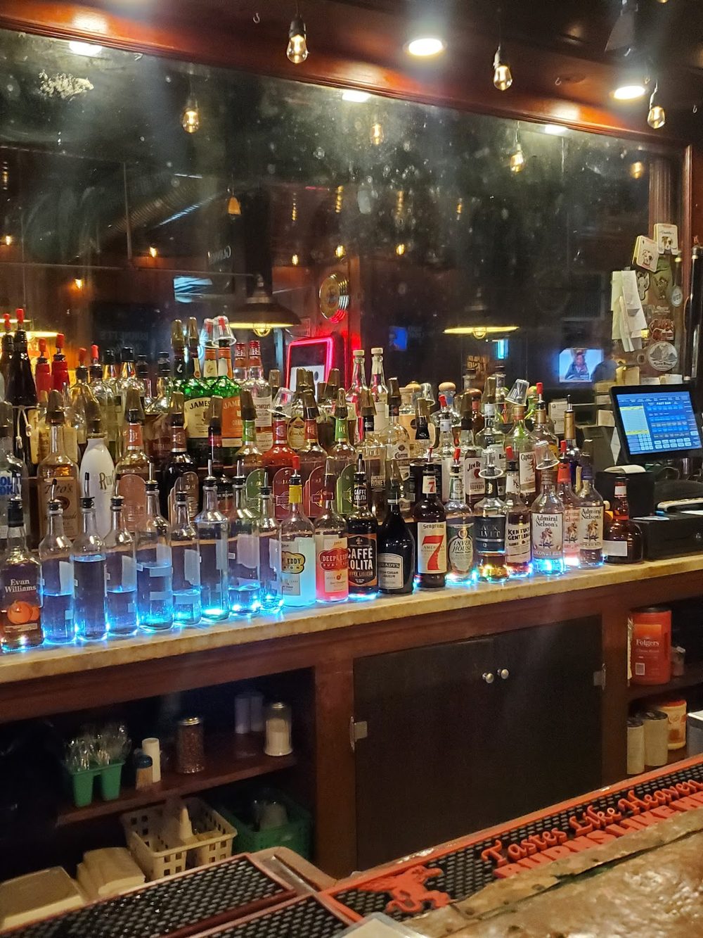 The fully stocked liquor shelf behind the bar